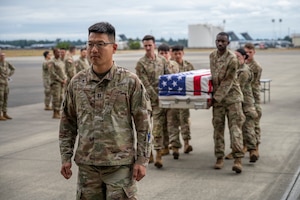 U.S. Army Capt. Se Jun Yu, Joint Base Lewis McChord chaplain resource manager, simulates a ramp ceremony during a dignified transfer training at Joint Base Lewis-McChord, Washington, July 10, 2025.
