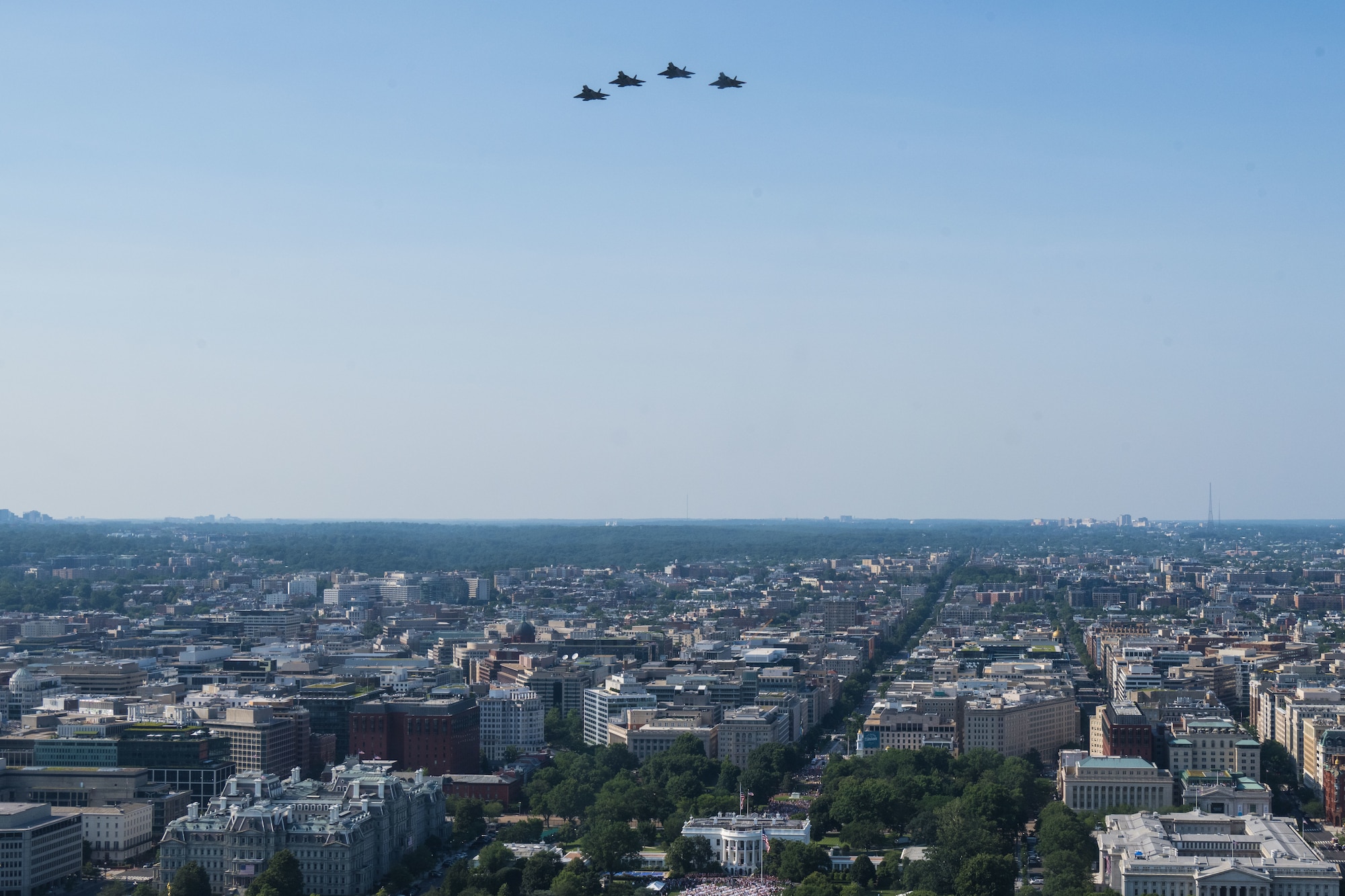 Four U.S. Air Force F-22 Raptors, conduct a flyover over the White House.