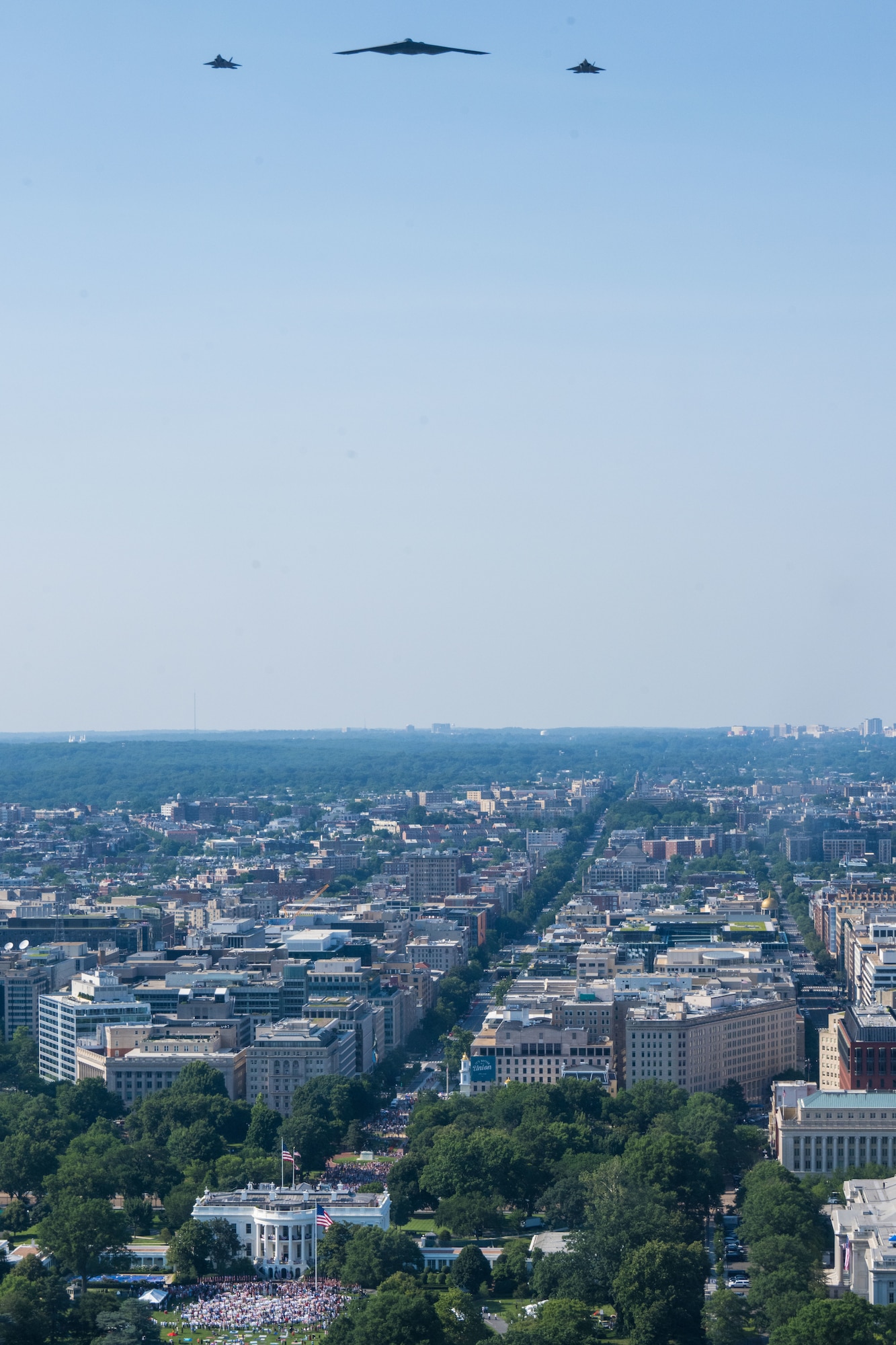 A U.S. Air Force B-2 Spirit and F-22 Raptors conduct a flyover over the White House.