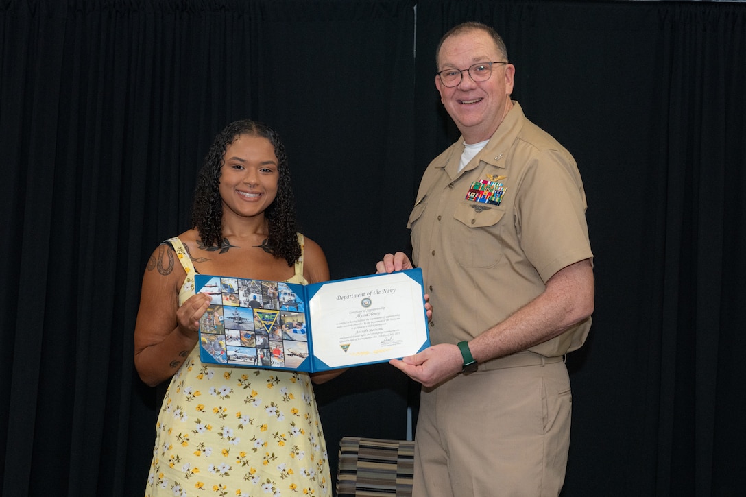 250711-N-DG679-1006
Alyssa Henry, a Fleet Readiness Center Southeast (FRCSE) 2025 graduating apprentice, accepts her journeyman certificate from FRCSE’s Executive Officer, Capt. Mike Freas. Henry is a newly designated journeyman-level aircraft mechanic. FRCSE’s apprenticeship program is a paid, four-year work study that provides benefits and the opportunity to learn a journeyman-level trade. (U.S. Navy Photo by Toiete Jackson)
