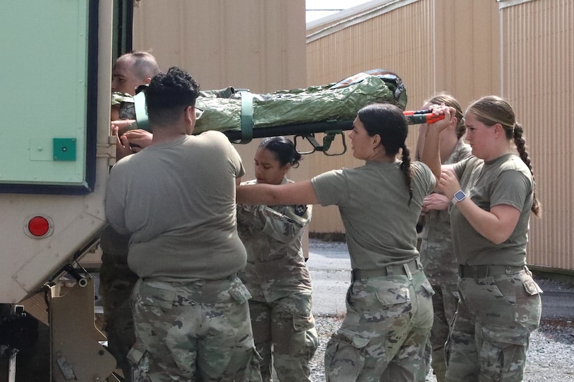 U.S. Soldiers with the 108th Medical Company Area Support, 213th Readiness Support Group, Pennsylvania Army National Guard, establish a medical facility and provide aid to combat casualties during the unit’s field medical exercise at Fort Indiantown Gap, Pennsylvania, July 16, 2025. The exercise simulates medical treatment, medical care and skills necessary to perform mission essential tasks in an austere environment. (U.S. Army National Guard photo by Spc. Annie M. Riley.)
