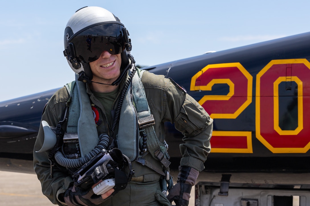 U.S. Marine Corps Maj. Erin Mathis, an operation officer with Marine Fighter Training Squadron (VMFT) 402, Marine Aircraft Group 41, 4th Marine Aircraft Wing, speaks to V2X veteran contractors after exiting an F-5N Tiger II aircraft assigned to Marine Fighter Training Squadron (VMFT) 402 during Atlantic Alliance 2025 at Joint Base Cape Cod, Massachusetts, July 3, 2025. VMFT-402’s purpose in Atlantic Alliance is to support and enhance Navy-Marine Corps amphibious operations by providing advanced fighter training and integrating air combat capabilities into joint and allied exercises along the East Coast. (U.S. Marine Corps photo by Sgt. Emely Gonzalez)