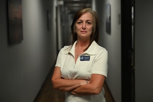 Alison Thorpe, 97th Maintenance Operations (MXO) training manager, poses in the MXO building hallway at Altus Air Force Base, Oklahoma, July 3, 2025. Thorpe is one of the few civilians who have won the Airman of the Month award. (U.S. Air Force photo by Airman 1st Class Nathan Langston)
