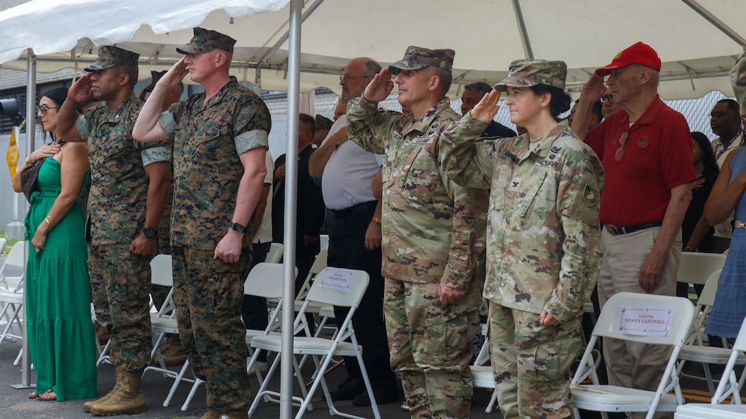 U.S. Marines and Soldiers salute the flag during the opening ceremony of the Robert Mullan Center, Fort Hamilton, New York, July 17, 2025. The ceremony was held to honor the opening of 1st Marine Corps District’s new headquarters after relocating from Garden City, New York.