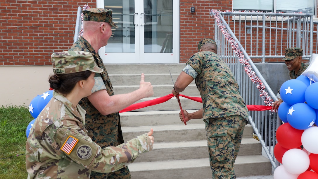 U.S. Marine Corps Col. Robert Jones (right), incoming commanding officer of 1st Marine Corps District, cuts the ceremonial ribbon during the opening ceremony of the Robert Mullan Center, Fort Hamilton, New York, July 17, 2025. The ceremony was held to honor the opening of 1st Marine Corps District’s new headquarters after relocating from Garden City, New York.