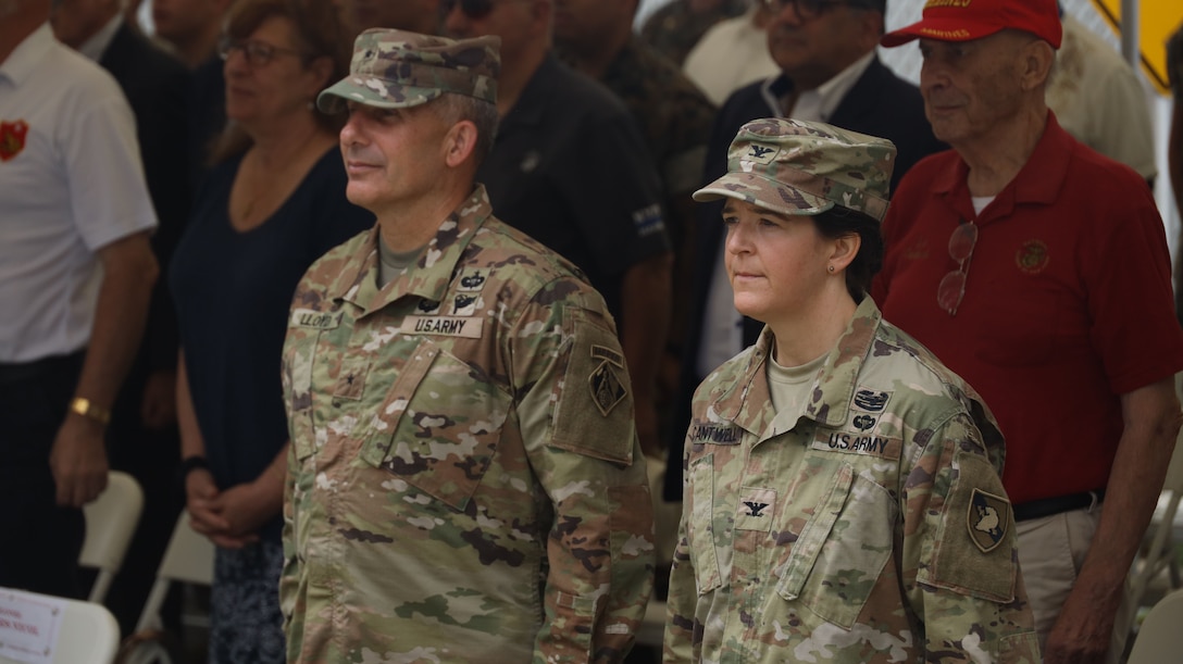 U.S. Army Brig. Gen. John Lloyd, commanding general of the U.S. Army Corps of Engineers North Atlantic Division, and Col. Melissa Cantwell, commanding officer of Fort Hamilton, stand at attention for the playing of Anchors Aweigh and the Marine Corps Hymn during the opening ceremony of the Robert Mullan Center, Fort Hamilton, New York, July 17, 2025. The ceremony was held to honor the opening of 1st Marine Corps District’s new headquarters after relocating from Garden City, New York.