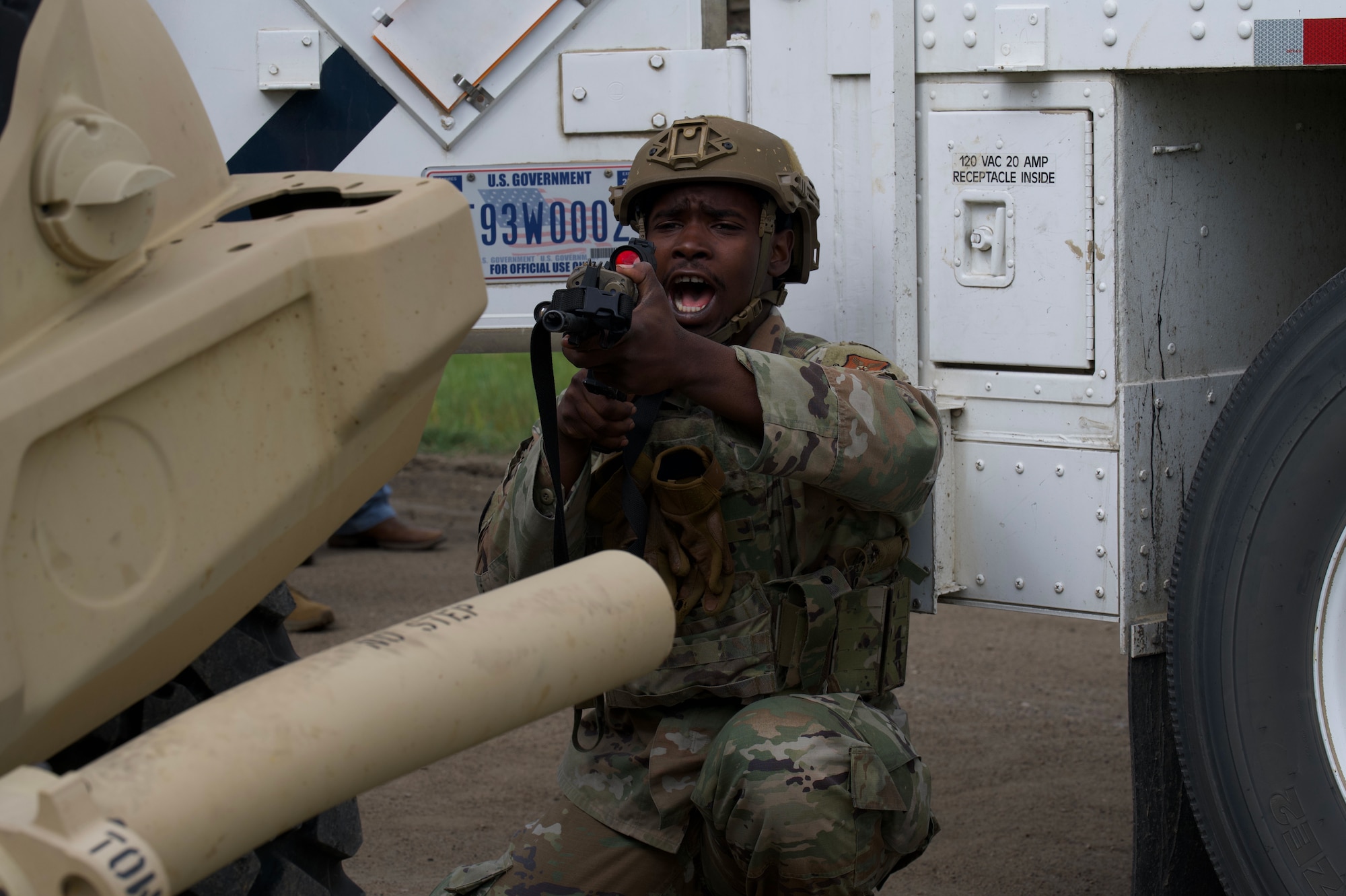 Airman 1st Class Michael Woods, 91st Missile Security Operations Squadron defender guards vehicle at Minot Air Force Base, North Dakota, July 11, 2025. Woods guarded the Joint Light Tactical Vehicle during the Bully Vigilance 25-1 exercise, designed to demonstrate the proficiency of defenders during a convoy.