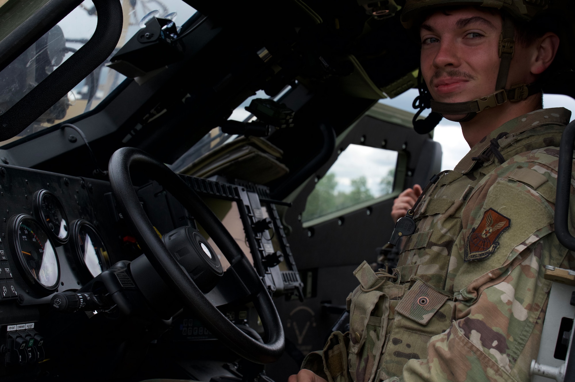 Airman 1st Class Bain Barkley, 91st Missile Security Operations Squadron defender, sits in a Joint Light Tactical Vehicle (JLTV) at Minot Air Force Base, North Dakota, July 11, 2025. Barkley operated the JLTV during exercise Bully Vigilance 25-1, which trains defenders to respond to external threats.