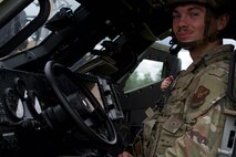 Airman 1st Class Bain Barkley, 91st Missile Security Operations Squadron defender, sits in a Joint Light Tactical Vehicle (JLTV) at Minot Air Force Base, North Dakota, July 11, 2025. Barkley operated the JLTV during exercise Bully Vigilance 25-1, which trains defenders to respond to external threats.