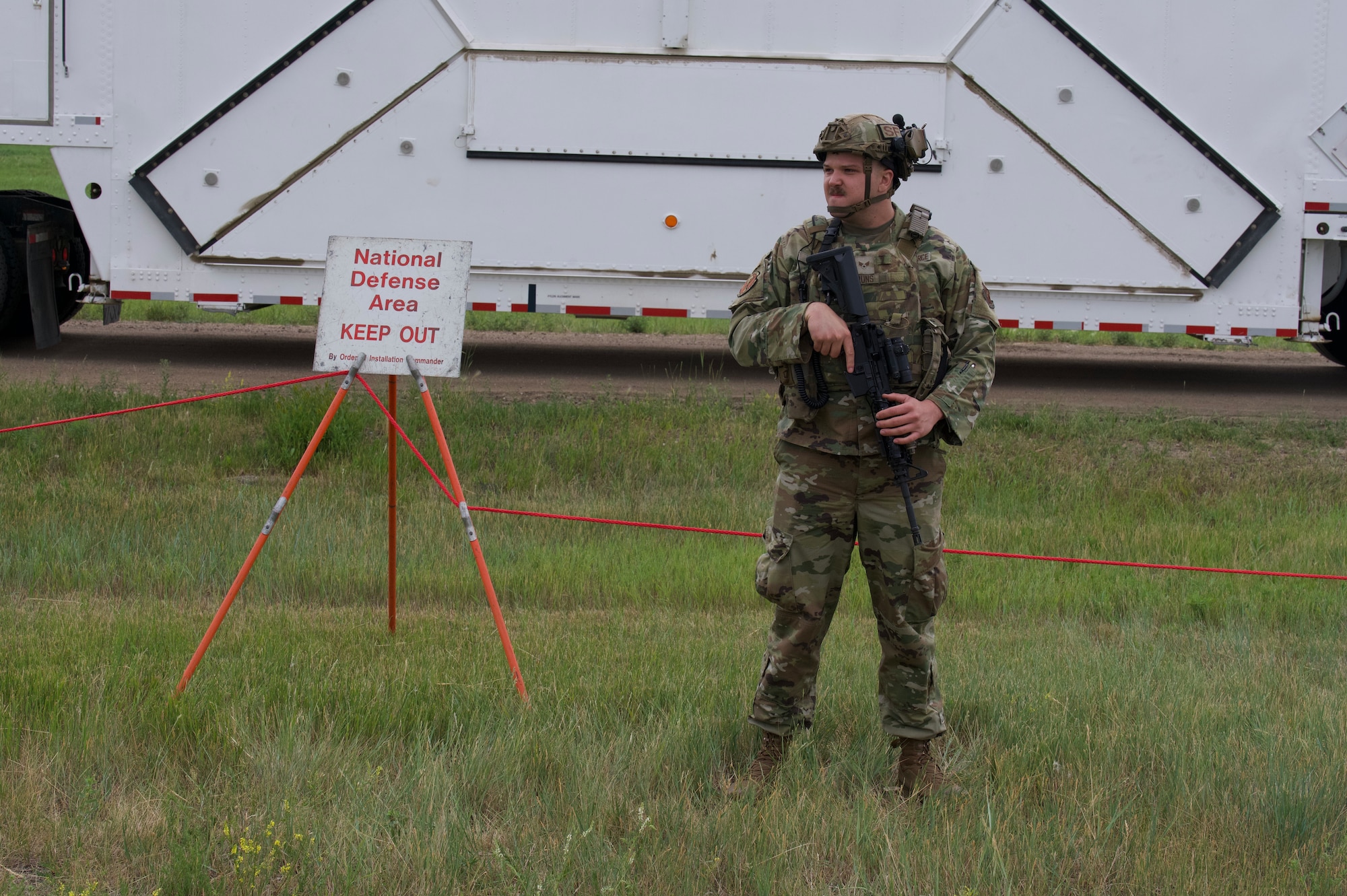 Senior Airman Drake Bruns, 91st Missile Security Operations Squadron defender guards the National Defense Area on Minot Air Force Base, North Dakota, July 11, 2025. Bruns guarded a convoy during the Bully Vigilance 25-1 exercise. Exercises like this allow Airmen to demonstrate their skills under the stress of a combat environment.