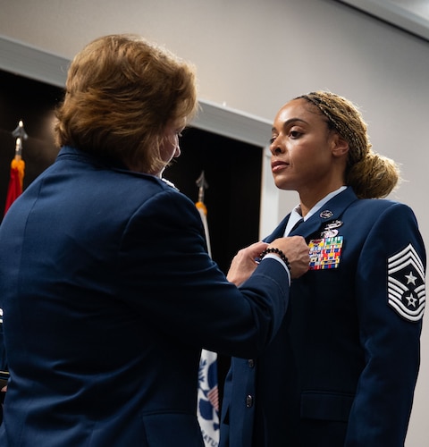 U.S. Air Force Chief Master Sgt. Khamillia Washington, outgoing 17th Training Wing command chief, receives the Legion of Merit from Col. Angelina Maguinness, 17th TRW commander, during the change of responsibility ceremony at the Powell Event Center, Goodfellow Air Force Base, Texas, July 16, 2025. Washington championed for Wing quality of life projects, secured 13 million dollars to replace the failing heat, ventilation and air conditioning system at the Louis F. Garland Department of Defense Fire Academy, obtained 5 million dollars for enhanced combat readiness training, guided the redesigning of a 158 million dollar intelligence exercise and enhanced firefighter performance with a 1.7 million dollar fire protection fleet biometrics project. (U.S. Air Force photo by Airman 1st Class Brian Lummus)