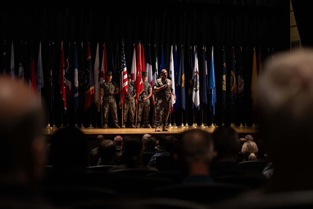 U.S. Marine Corps Col. Garth W. Burnett, outgoing commanding officer, Marine Corps Air Station (MCAS) New River, gives his remarks during a change of command ceremony at MCAS New River in Jacksonville, North Carolina, July 17, 2025. The ceremony represented the transfer of responsibility, authority and accountability from the outgoing to the incoming commanding officer. (U.S. Marine Corps photo by Cpl. Loriann Dauscher)
