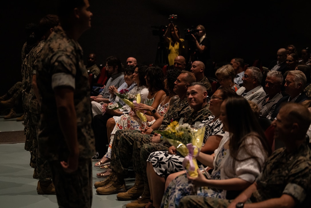 The family members of U.S. Marine Corps leaders of Marine Corps Air Station (MCAS) New River receive flowers during a change of command ceremony at MCAS New River in Jacksonville, North Carolina, July 17, 2025. The ceremony represented the transfer of responsibility, authority and accountability from the outgoing to the incoming commanding officer. (U.S. Marine Corps photo by Cpl. Loriann Dauscher)