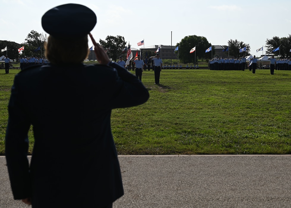 Members of the 17th Training Wing present a final salute to U.S. Air Force Col. Angelina Maguinness, outgoing 17th TRW commander, during the change of command ceremony at Goodfellow Air Force Base, Texas, July 17, 2025. The final salute represents a “thank you” to the outgoing commander for their leadership. (U.S. Air Force photo by Staff Sergeant Nathan Call)