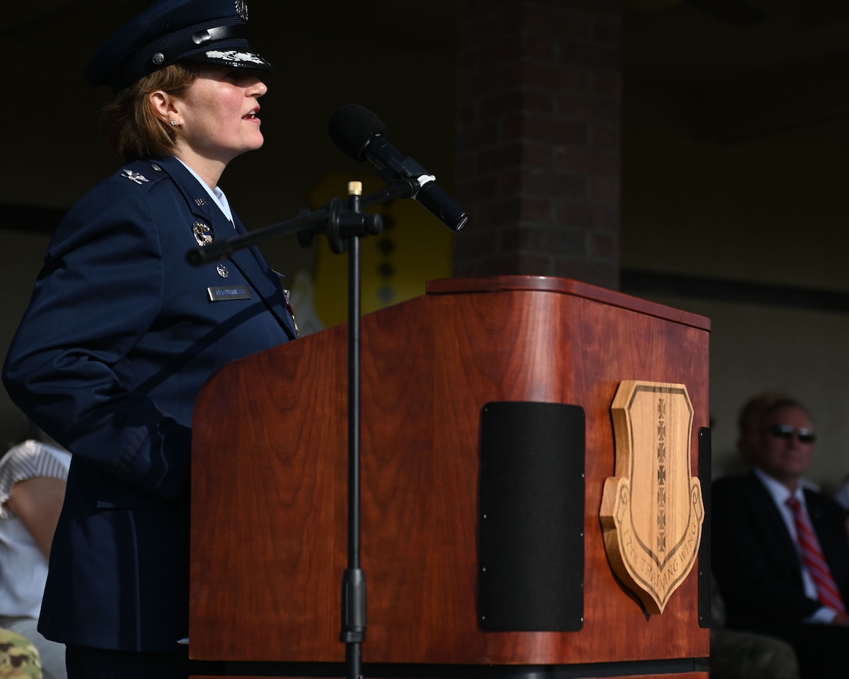 U.S. Air Force Col. Angelina Maguinness, 17th Training Wing outgoing commander, speaks during the 17th TRW change of command ceremony at Goodfellow Air Force Base, Texas, July 17, 2025. The change of command ceremony is a military tradition, which illustrates the formal transfer of authority by the passing of the guidon from departing commander to incoming commander. (U.S. Air Force photo by Staff Sergeant Nathan Call)