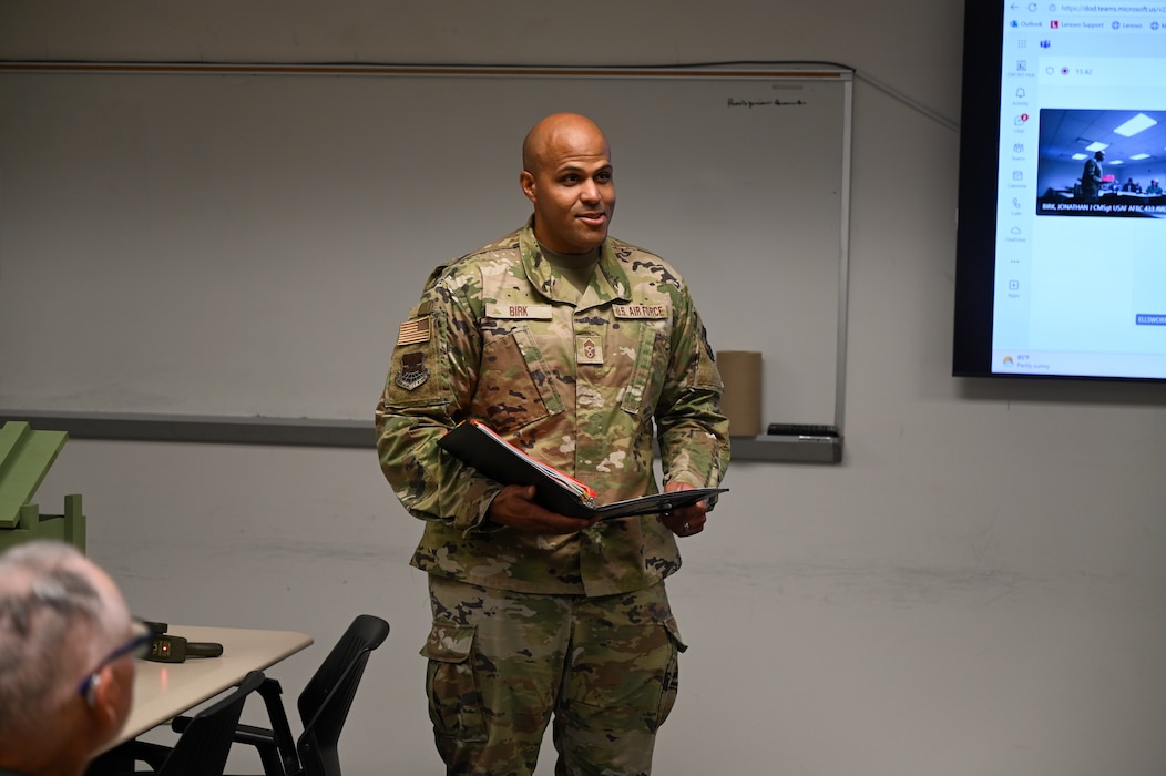 Chief Master Sgt. Jonathan Birk, 433rd Airlift Wing command chief, reads the rules associated with the Jeep Chief tradition during an informal ceremony recognizing the wing’s most recently promoted Chief Master Sergeant at Joint Base San Antonio-Lackland, Texas, July 12, 2025.