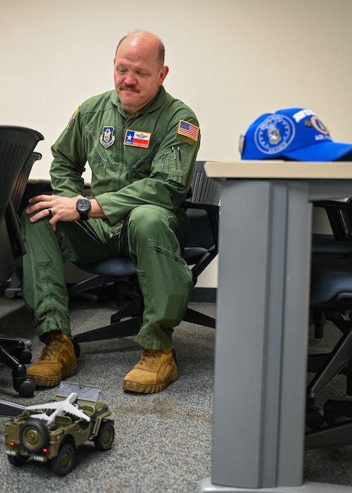 Chief Master Sgt. Jeremy Everly, 433rd Aeromedical Evacuation Squadron senior enlisted leader, receives a toy Jeep associated with the Jeep Chief tradition during an informal ceremony at Joint Base San Antonio-Lackland, Texas, July 12, 2025.