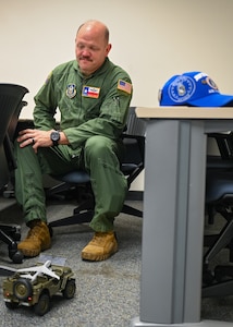 Chief Master Sgt. Jeremy Everly, 433rd Aeromedical Evacuation Squadron senior enlisted leader, receives a toy Jeep associated with the Jeep Chief tradition during an informal ceremony at Joint Base San Antonio-Lackland, Texas, July 12, 2025.