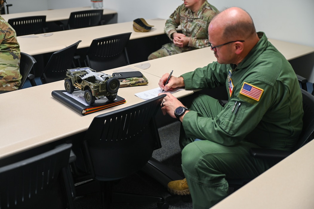 Chief Master Sgt. Jeremy Everly, 433rd Aeromedical Evacuation Squadron senior enlisted leader, takes notes during a mentoring session following an informal ceremony which designated him as the 433rd Airlift Wing’s “Jeep Chief” at Joint Base San Antonio-Lackland, Texas, July 12, 2025.