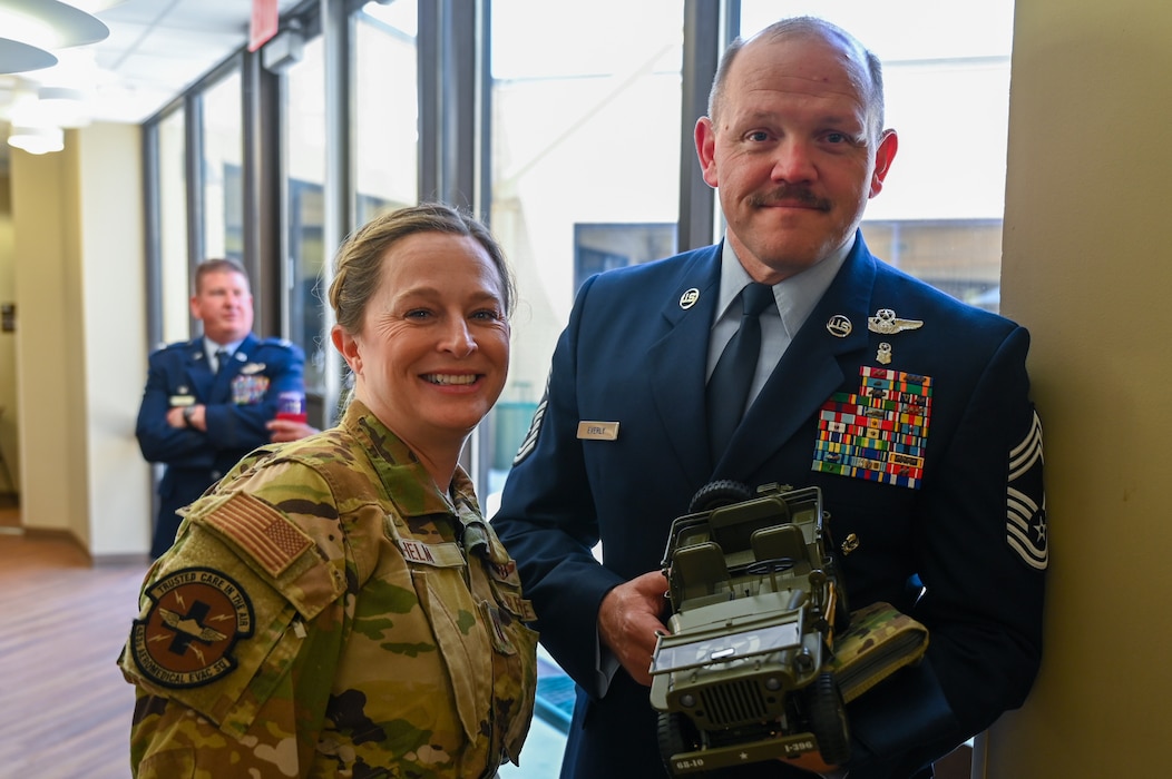 Chief Master Sgt. Jeremy Everly, 433rd Aeromedical Evacuation Squadron senior enlisted leader, poses for a photo with Capt. Courtney Helm, a 433rd AES flight nurse, and the toy Jeep he is charged with caring for as part of the Jeep Chief tradition at Joint Base San Antonio-Lackland, Texas, July 12, 2025.