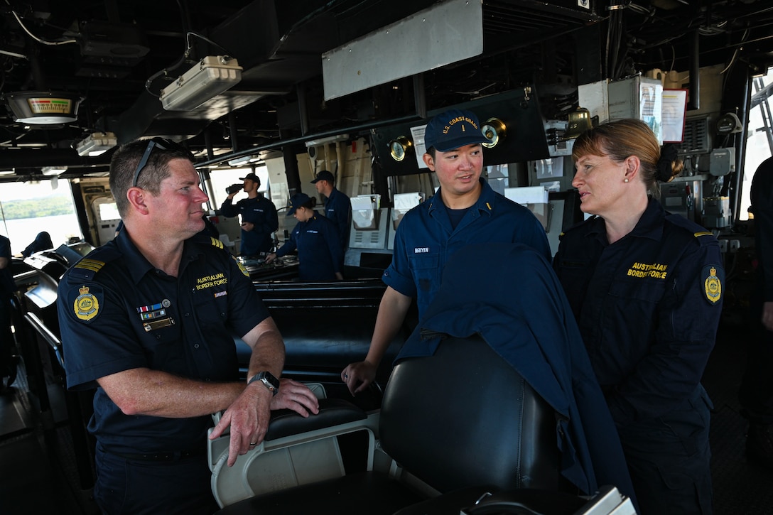 Ensign Duylam Nguyen, middle, a crewmember assigned to the Legend-class U.S. Coast Guard Cutter Stratton (WMSL 752), speaks with Australian Border Force officers, during a mooring evolution in Apra Harbor, Guam, July 2, 2025. Stratton is deployed and assigned to Destroyer Squadron (DESRON) 15, the Navy’s largest DESRON and the U.S. 7th Fleet’s principal surface force. Stratton is deployed to the Indo-Pacific to advance relationships with ally and partner nations to build a more secure and prosperous region with unrestricted, lawful access to the maritime commons. (U.S. Coast Guard photo by Petty Officer 2nd Class Kate Kilroy)