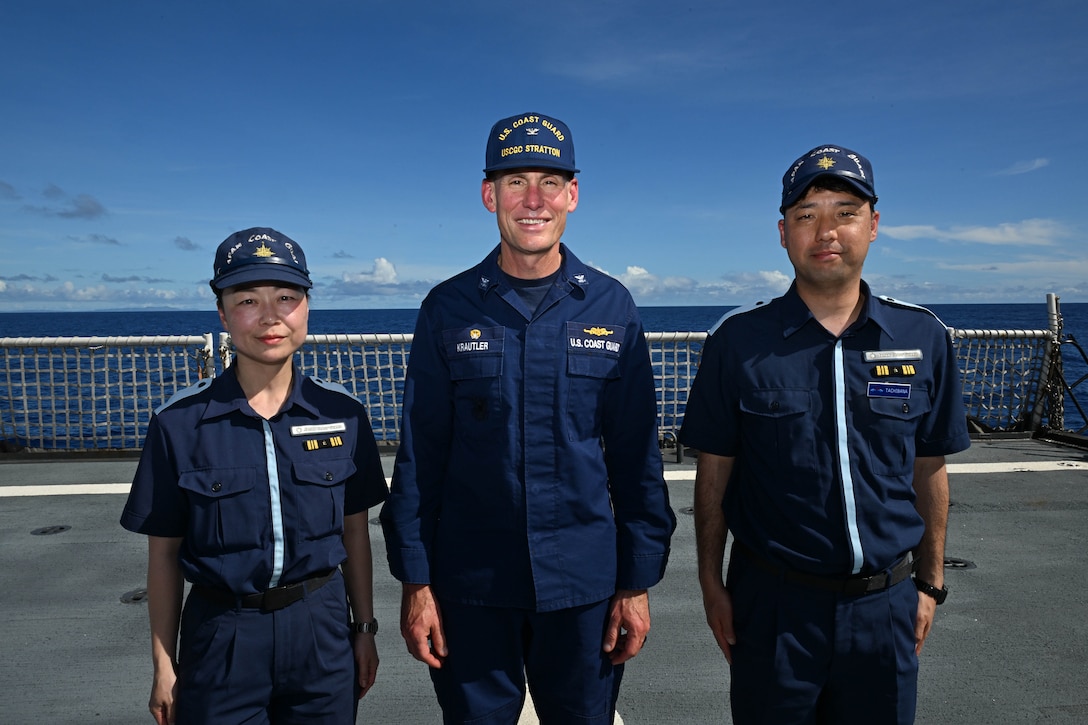 Japan Coast Guard members Lt. Cmdr. Mio Ando, left, and Lt. Cmdr. Yusuke Tachibana, right, take a photo with the Legend-class U.S. Coast Guard Cutter Stratton (WMSL 752) Commanding Officer Capt. Brian Krautler while patrolling the Pacific Ocean, July 1, 2025. Stratton is deployed and assigned to Destroyer Squadron (DESRON) 15, the Navy’s largest DESRON and the U.S. 7th Fleet’s principal surface force. Stratton is deployed to the Indo-Pacific to advance relationships with ally and partner nations to build a more secure and prosperous region with unrestricted, lawful access to the maritime commons. (U.S. Coast Guard photo by Petty Officer 2nd Class Kate Kilroy)