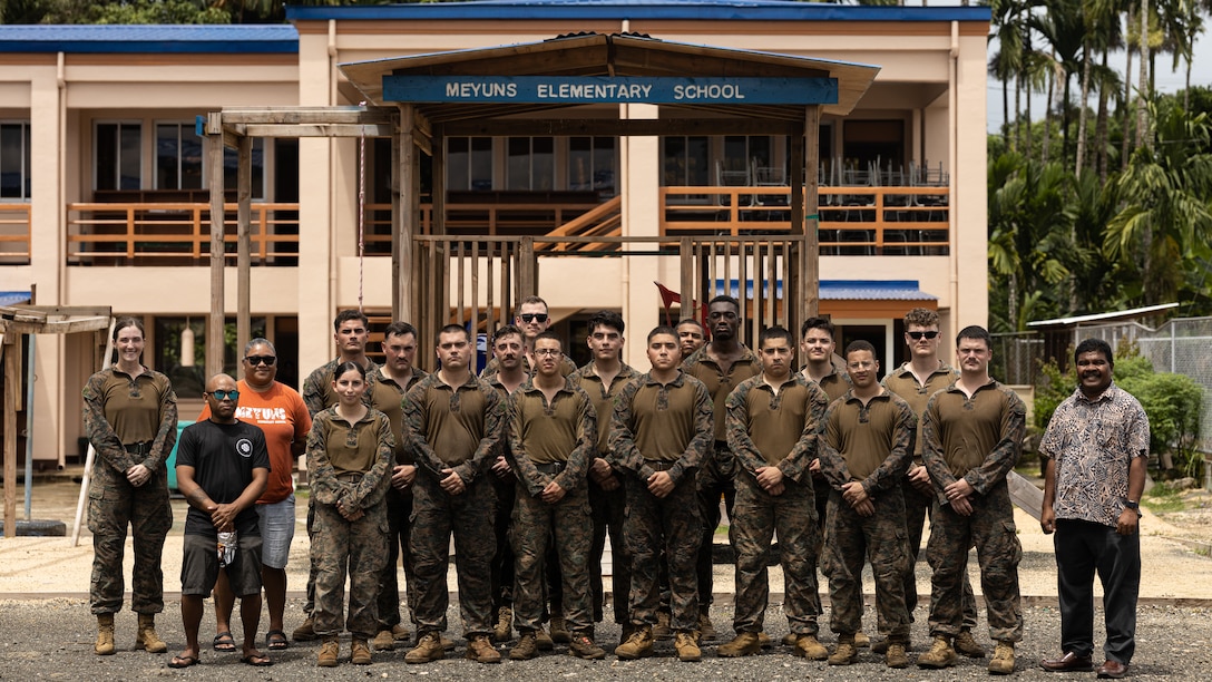 U.S. Marines with Combat Logistics Battalion 15, Combat Logistics Regiment 17, 1st Marine Logistics Group, and Meyuns Elementary School staff pose for a photo during Koa Moana 25 in Palau, July 15, 2025.