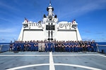 Quad partners from the U.S. Coast Guard, Japan Coast Guard, Australian Border Force, Indian Coast Guard and the command and crew of the Legend-class U.S. Coast Guard Cutter Stratton (WMSL 752) take a photo on the flight deck during the first Quad at-sea mission while Stratton patrols the Pacific Ocean, July 1, 2025. Stratton is deployed and assigned to Destroyer Squadron (DESRON) 15, the Navy’s largest DESRON and the U.S. 7th Fleet’s principal surface force. Stratton is deployed to the Indo-Pacific to advance relationships with ally and partner nations to build a more secure and prosperous region with unrestricted, lawful access to the maritime commons. (U.S. Coast Guard photo by Petty Officer 2nd Class Kate Kilroy)