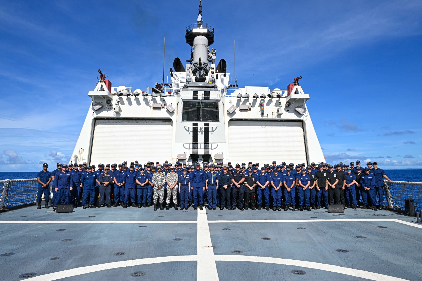 Quad partners from the U.S. Coast Guard, Japan Coast Guard, Australian Border Force, Indian Coast Guard and the command and crew of the Legend-class U.S. Coast Guard Cutter Stratton (WMSL 752) take a photo on the flight deck during the first Quad at-sea mission while Stratton patrols the Pacific Ocean, July 1, 2025. Stratton is deployed and assigned to Destroyer Squadron (DESRON) 15, the Navy’s largest DESRON and the U.S. 7th Fleet’s principal surface force. Stratton is deployed to the Indo-Pacific to advance relationships with ally and partner nations to build a more secure and prosperous region with unrestricted, lawful access to the maritime commons. (U.S. Coast Guard photo by Petty Officer 2nd Class Kate Kilroy)