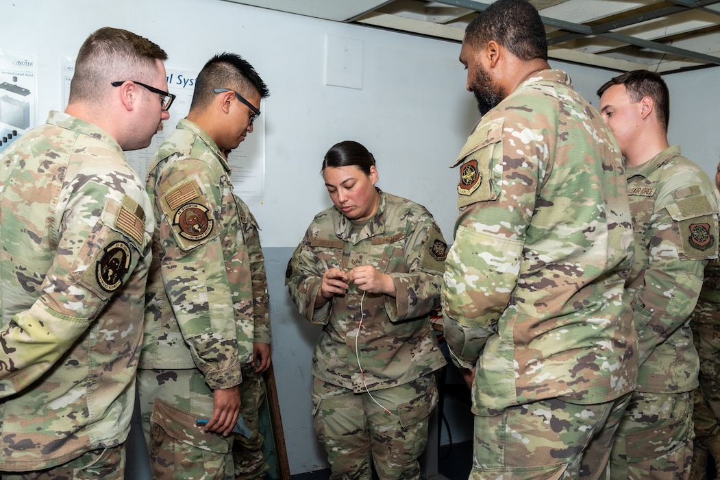 Instructor explains wiring to Airmen