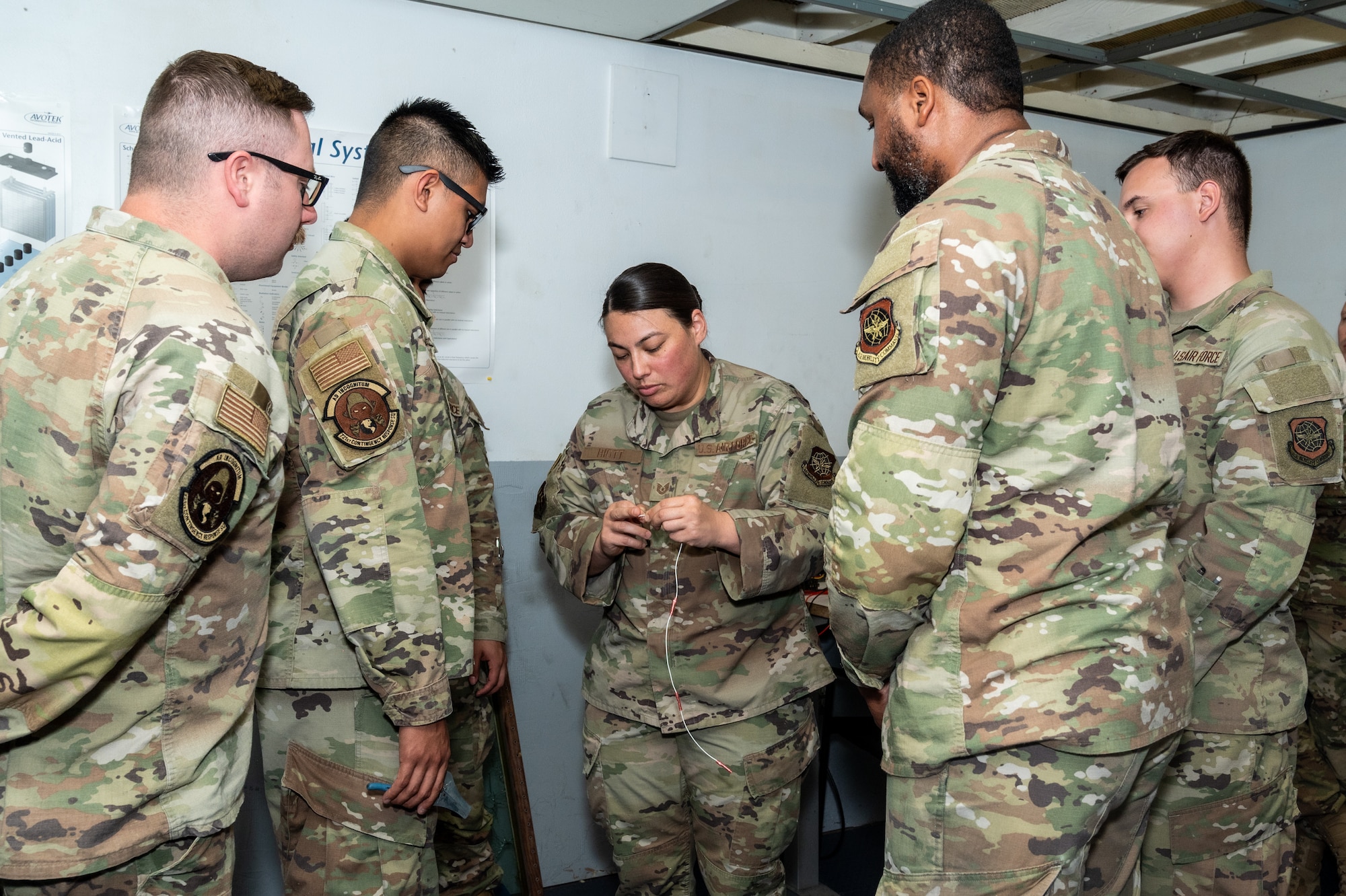 Instructor explains wiring to Airmen