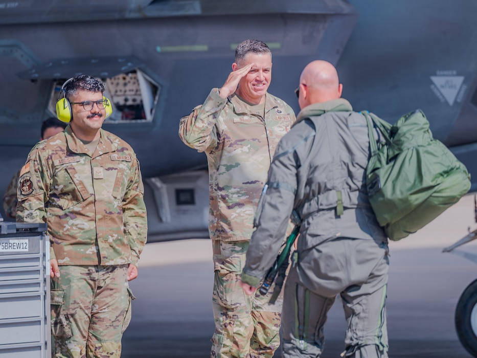 U.S. Air Force Chief Master Sgt. Jason Shaffer (center), 56th Fighter Wing command chief, and Airman First Class Ninort Audisho (left), 310th Aircraft Maintenance Unit crew chief, greet Brig. Gen. David Berkland (right), 56th Fighter Wing commander, on the flightline, July 16, 2025, at Luke Air Force Base, Arizona.