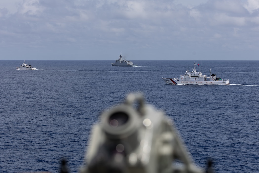 From right, the Philippine Coast Guard (PCG) Parola-class patrol vessel BRP Cabra (MRRV-4409), the first-in-class Philippine Navy (PN) guided-missile frigate BRP Miguel Malvar (FFG-06), and the Philippine Coast Guard (PCG) Parola-class patrol vessel BRP Suluan (MRRV-4406), steam ahead of the Arleigh Burke-class guided-missile destroyer USS Curtis Wilbur (DDG 54) for a photo exercise during bilateral Maritime Cooperative Activity in the South China Sea, July 16, 2025.