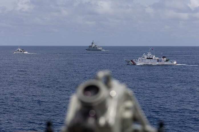 From right, the Philippine Coast Guard (PCG) Parola-class patrol vessel BRP Cabra (MRRV-4409), the first-in-class Philippine Navy (PN) guided-missile frigate BRP Miguel Malvar (FFG-06), and the Philippine Coast Guard (PCG) Parola-class patrol vessel BRP Suluan (MRRV-4406), steam ahead of the Arleigh Burke-class guided-missile destroyer USS Curtis Wilbur (DDG 54) for a photo exercise during bilateral Maritime Cooperative Activity in the South China Sea, July 16, 2025.