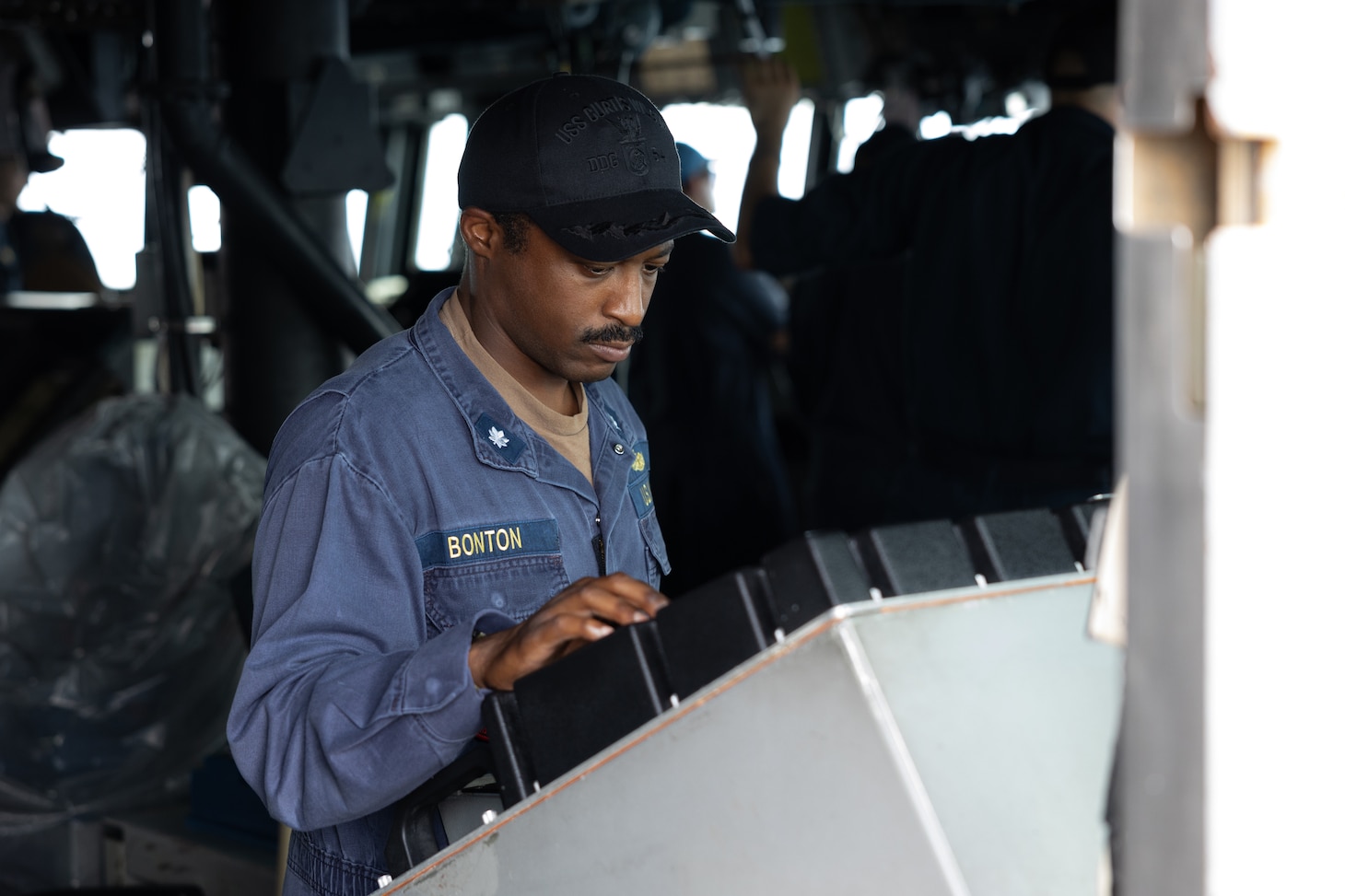 SOUTH CHINA SEA - Cmdr. Brandon Bonton, executive officer of the Arleigh Burke-class guided-missile destroyer USS Curtis Wilbur (DDG 54), operates the navigation radar on the bridge during Maritime Cooperative Activity with the Armed Forces of the Philippines and the Philippine Coast Guard in the South China Sea, July 16, 2025. Curtis Wilbur is assigned to Destroyer Squadron (DESRON) 15, the Navy’s largest DESRON and U.S. 7th Fleet’s principal surface force. (U.S. Navy photo by Mass Communication Specialist Seaman Mark Bergado)