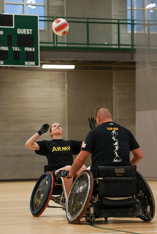 U.S. Army Capt. Samantha Frey, left, and Sgt. 1st Class Adam Proctor compete for the ball at wheelchair rugby practice during the 2025 Department of Defense Warrior Games practice sessions at Fort Carson, Colorado, July 14, 2025.