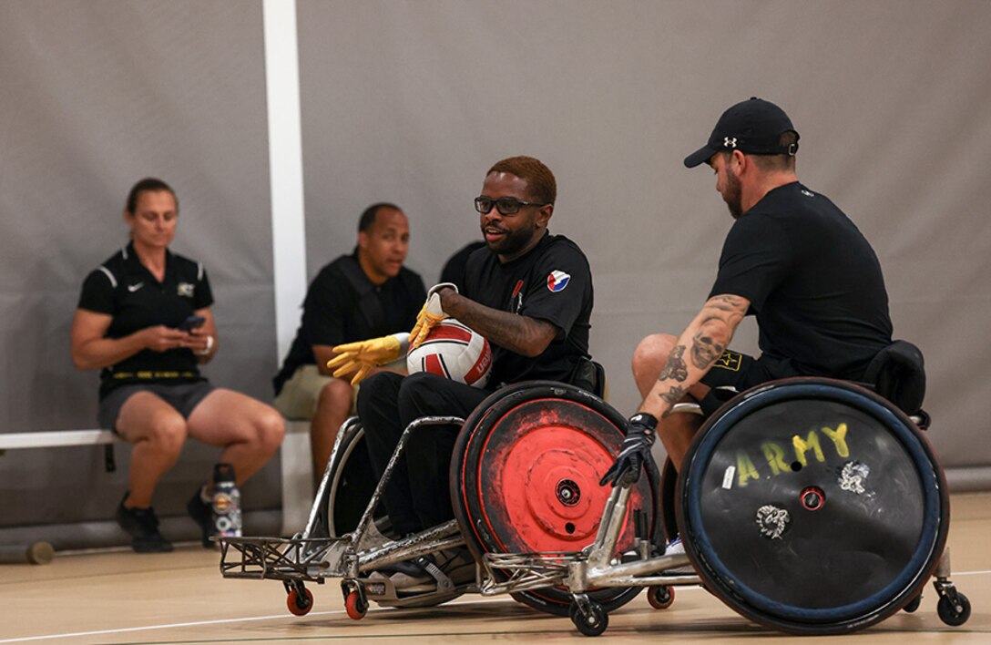 U.S. Army Staff Sgt. Allaijah Churchwell and veteran John Michael Britton conduct drills at wheelchair rugby practice during the 2025 Department of Defense Warrior Games practice sessions at Fort Carson, Colorado, July 14, 2025.