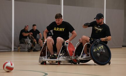 U.S. Army Staff Sgt. Coty Tuck, left, and veteran John Michael Britton conduct drills at  wheelchair rugby practice during the 2025 Department of Defense Warrior Games practice sessions at Fort Carson, Colorado, July 14, 2025.