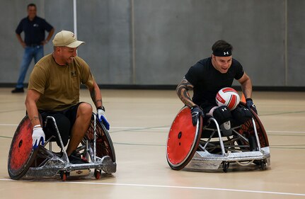 U.S. Army veterans Anthony Farve, left, and J.P. Lane conduct warm-up drills at wheelchair rugby practice during the 2025 Department of Defense Warrior Games practice sessions at Fort Carson, Colorado, July 14, 2025.