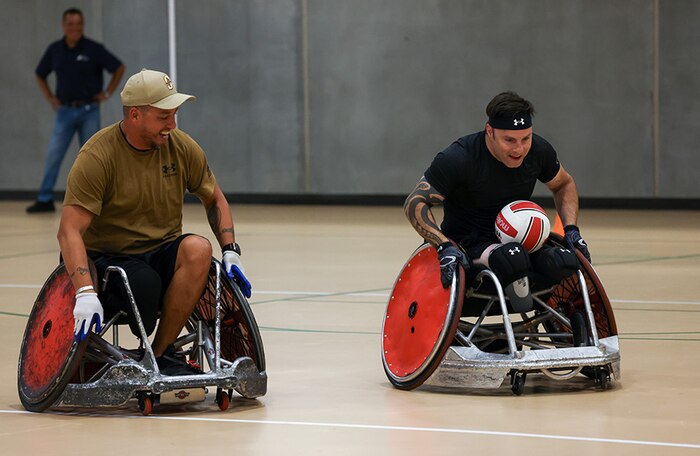 U.S. Army veterans Anthony Farve, left, and J.P. Lane conduct warm-up drills at wheelchair rugby practice during the 2025 Department of Defense Warrior Games practice sessions at Fort Carson, Colorado, July 14, 2025.
