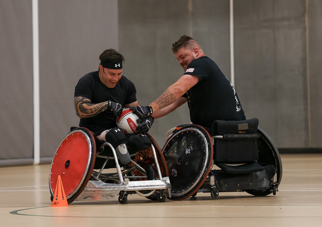 U.S. Army veteran J.P. Lane, left, and Sgt. 1st Class Adam Proctor compete for the ball while conducting drills at wheelchair rugby practice during the 2025 Department of Defense Warrior Games practice sessions at Fort Carson, Colorado, July 14, 2025.