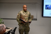 Chief Master Sgt. Jonathan Birk, 433rd Airlift Wing command chief, reads the rules associated with the Jeep Chief tradition during an informal ceremony recognizing the wing’s most recently promoted Chief Master Sergeant at Joint Base San Antonio-Lackland, Texas, July 12, 2025.