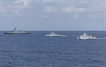 SOUTH CHINA SEA - From left, the first-in-class Philippine Navy (PN) guided-missile frigate BRP Miguel Malvar (FFG-06), and the Parola-class Philippine Coast Guard (PCG) patrol vessels BRP Cabra (MRRV-4409) and BRP Suluan (MRRV-4406) steam in formation for a photo exercise with the Arleigh Burke-class guided-missile destroyer USS Curtis Wilbur (DDG 54) during Maritime Cooperative Activity in the South China Sea, July 16, 2025. Curtis Wilbur is assigned to Destroyer Squadron (DESRON) 15, the Navy’s largest DESRON and U.S. 7th Fleet’s principal surface force. (U.S. Navy photo by Mass Communication Specialist Seaman Mark Bergado)