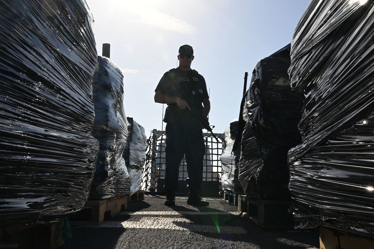 U.S. Coast Guard Petty Officer 1st Class Tyler Mace, a gunner’s mate assigned to USCGC Resolute (WMEC 620), stands overwatch of illicit narcotics during a drug offload at Coast Guard Sector St. Petersburg, July 17, 2025. Resolute spent several weeks as the only U.S. Coast Guard cutter in the Eastern Pacific, playing a critical role in maintaining maritime domain awareness and operational coverage across a vast area, spanning over one million square miles. (U.S. Coast Guard photo by Petty Officer 1st Class Riley Perkofski)