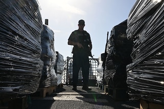 U.S. Coast Guard Petty Officer 1st Class Tyler Mace, a gunner’s mate assigned to USCGC Resolute (WMEC 620), stands overwatch of illicit narcotics during a drug offload at Coast Guard Sector St. Petersburg, July 17, 2025. Resolute spent several weeks as the only U.S. Coast Guard cutter in the Eastern Pacific, playing a critical role in maintaining maritime domain awareness and operational coverage across a vast area, spanning over one million square miles. (U.S. Coast Guard photo by Petty Officer 1st Class Riley Perkofski)