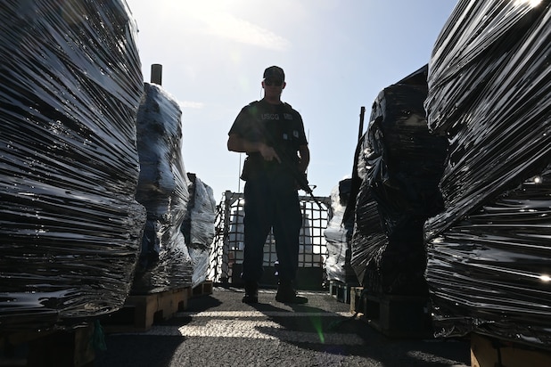 U.S. Coast Guard Petty Officer 1st Class Tyler Mace, a gunner’s mate assigned to USCGC Resolute (WMEC 620), stands overwatch of illicit narcotics during a drug offload at Coast Guard Sector St. Petersburg, July 17, 2025. Resolute spent several weeks as the only U.S. Coast Guard cutter in the Eastern Pacific, playing a critical role in maintaining maritime domain awareness and operational coverage across a vast area, spanning over one million square miles. (U.S. Coast Guard photo by Petty Officer 1st Class Riley Perkofski)