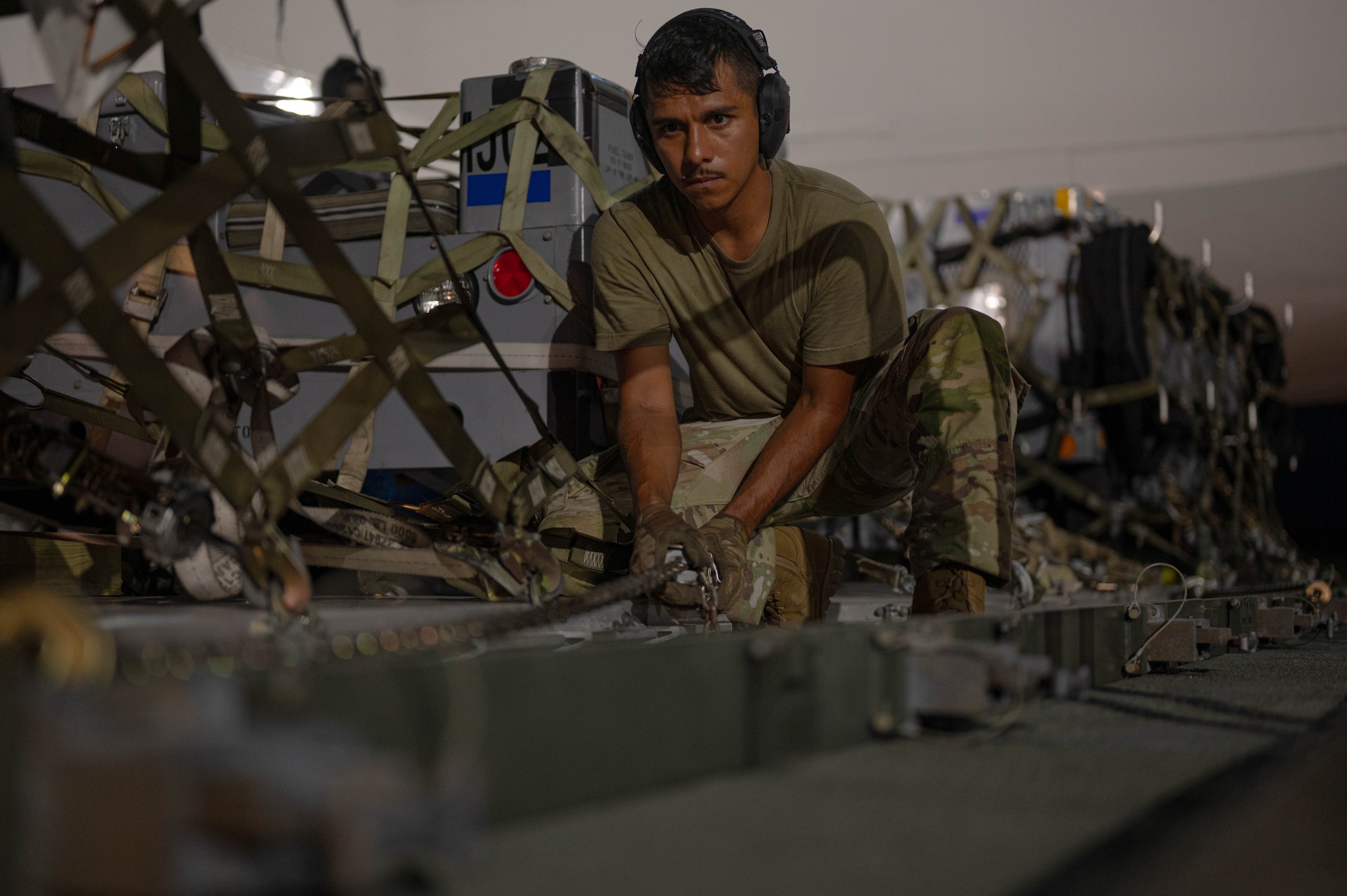 U.S. Air Force Senior Airman Christopher Geer Jr., 325th Logistics Readiness Squadron air transportation function craftsman, secures cargo onto a Tunner 60K loader at Tyndall Air Force Base, Florida.