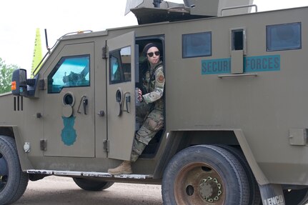 Airman 1st Class Abigail Goodner, 91st Missile Security Operations Squadron defender, checks her surroundings on Minot Air Force Base, North Dakota July 11, 2025. Goodner served as a member of the fire observers during the Bully Vigilance 25-1, an exercise designed to demonstrate the proficiency of defenders during a convoy.