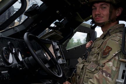 Airman 1st Class Bain Barkley, 91st Missile Security Operations Squadron defender, sits in a Joint Light Tactical Vehicle (JLTV) at Minot Air Force Base, North Dakota, July 11, 2025. Barkley operated the JLTV during exercise Bully Vigilance 25-1, which trains defenders to respond to external threats.