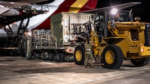 U.S. Airmen load cargo onto a Boeing 747 aircraft